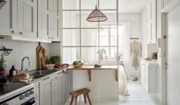 Small flat with the bedroom behind a glass partition in the kitchen