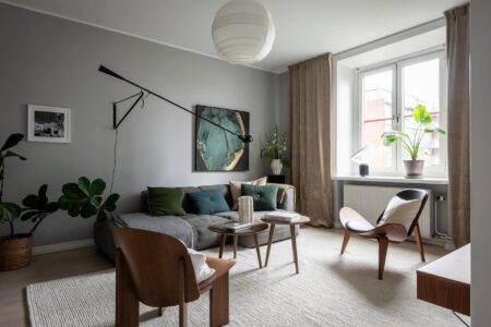 A Historic Flat With Grey Walls Green Accents And A Dark Blue Bedroom1.jpg