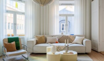 A gorgeous historic apartment with a white and gold shaker kitchen