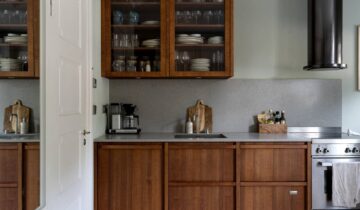 A luxurious studio space with a walnut kitchen