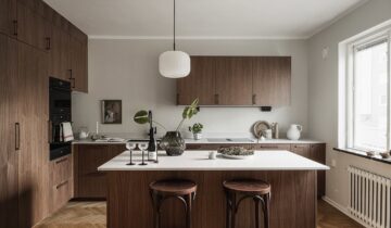 A dark wood kitchen and dark accent furniture pieces for a cozy effect