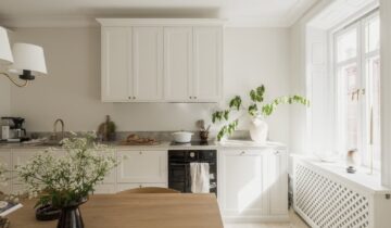 A white shaker kitchen and a fresh white interior in a historic flat