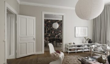 A dining room with a bold floral wallpaper in a historic apartment