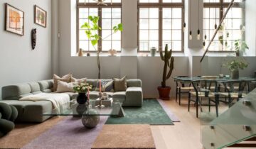 A spacious loft apartment wiht a grey kitchen and pink walls