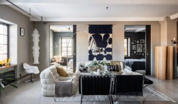 A grey home with a dark oak kitchen and concrete flooring