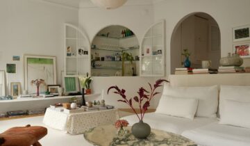 A white interior with curved windows and doors in a historic flat
