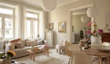 A cozy historic flat with a muted color palette and pink kitchen walls