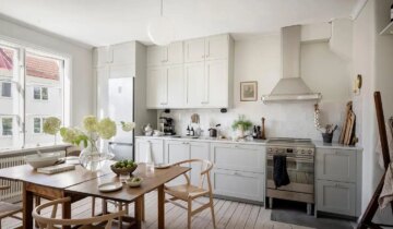 A light grey shaker kitchen paired with a pastel green bedroom